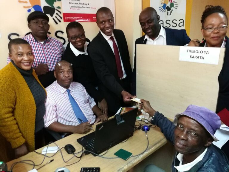 SASSA beneficiary handed a gold card at local office for grant payment, greeted by officials, Gold Cards Still Valid for SASSA Grant Payments in June 2025