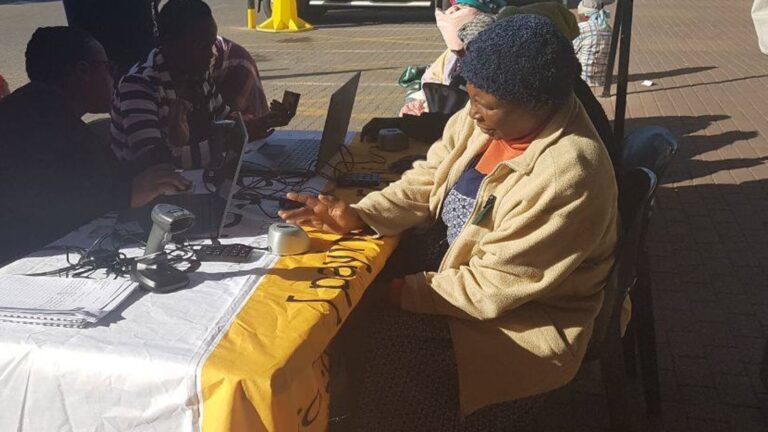 Old Age beneficiary completing ID verification and biometric fingerprint scan at a local SASSA office, SASSA ID Verification for June 2025 Grant Payments