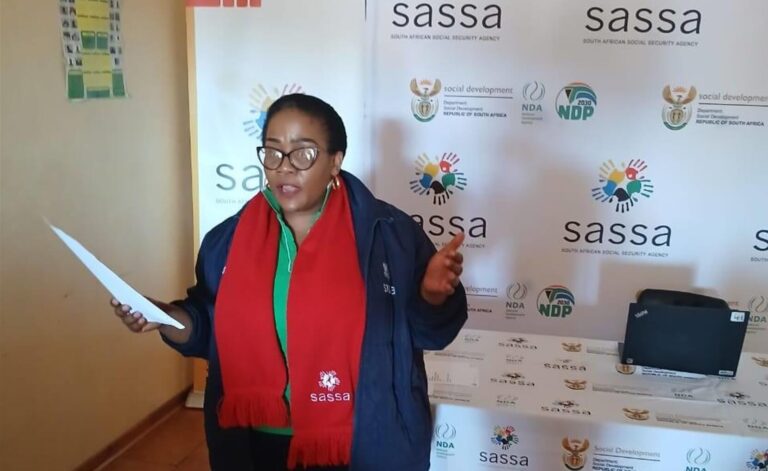 SASSA representative addresses beneficiaries during a community outreach event to raise awareness about SASSA services, July 2025 SASSA Status Check: Avoid Missed Payments
