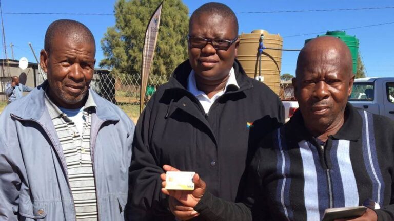 SASSA Gold Card holder visiting service point to upgrade to new Postbank Black Card, SASSA Beneficiaries Must Switch to Postbank Black Cards by July 2025
