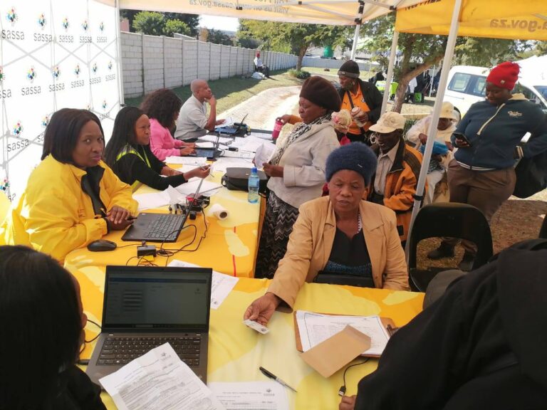 SASSA elderly beneficiary verifying identity for July 2025 old age grant payment at mobile outreach site, SASSA Old Age Grant Status Check: Pay Day 2 July 2025